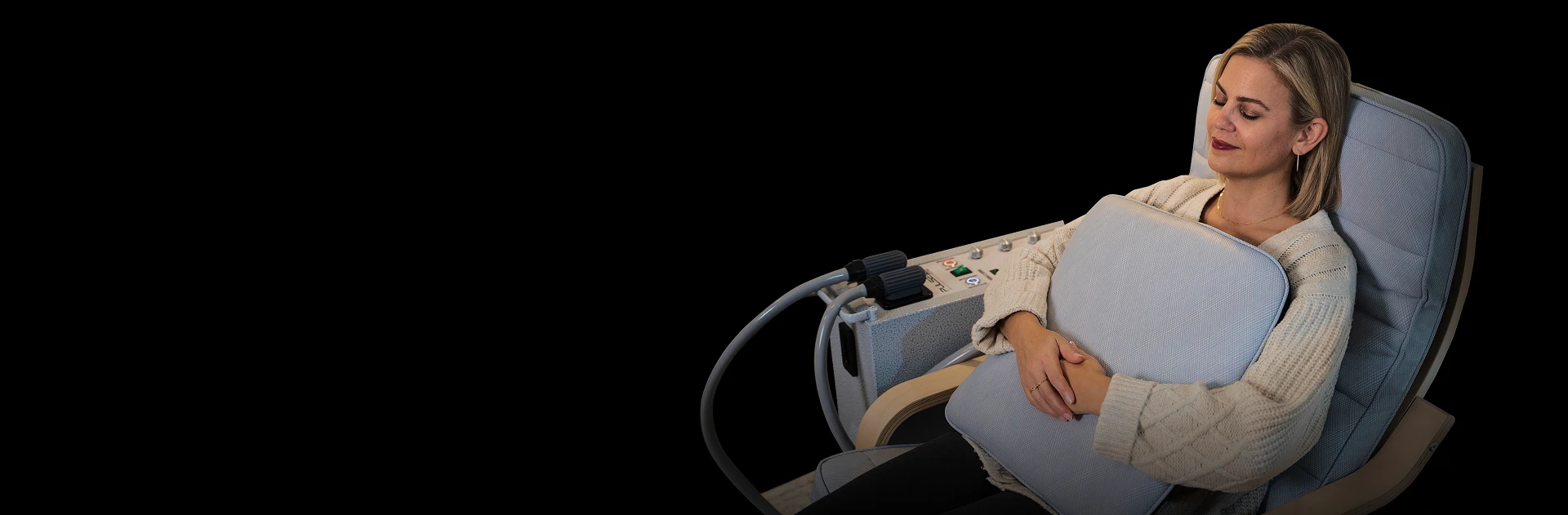 A client resting in a Pulse PEMF chair, eyes closed, at ease